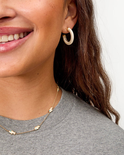 LE TUBE HOOP EARRINGS IN CREAM