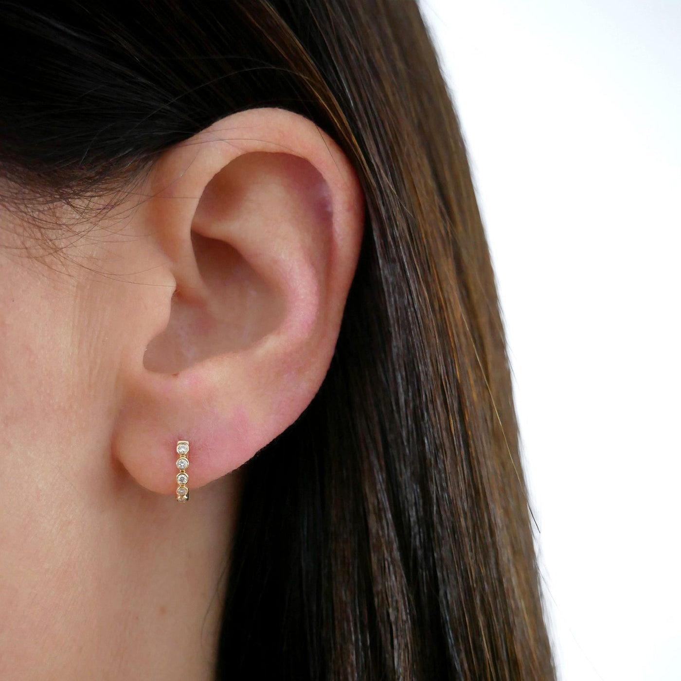 DIAMOND BEZEL MINI HUGGIE EARRING IN 14K YELLOW GOLD